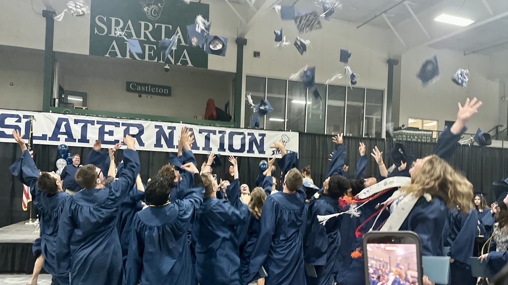 Members of the Fair Haven Union High School Class of 2026 process across the floor in blue caps and gowns following the ceremony, many carrying diplomas and celebrating together.
