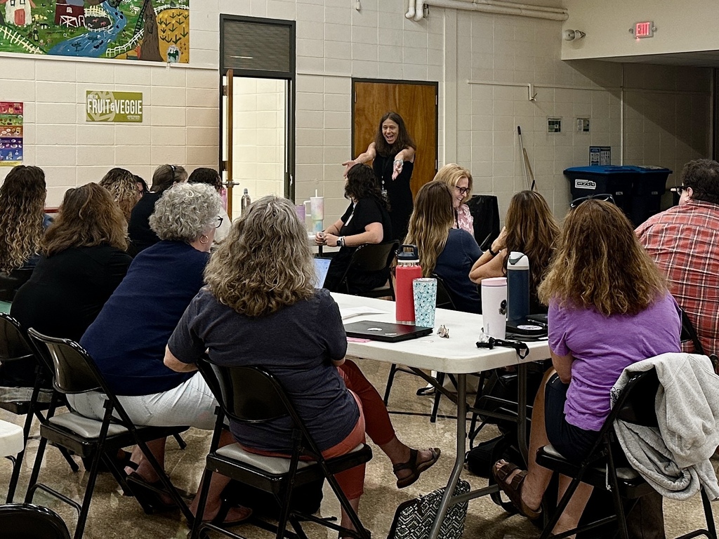 Slate Valley special educators sit at tables during a professional learning session as a presenter speaks to the group.