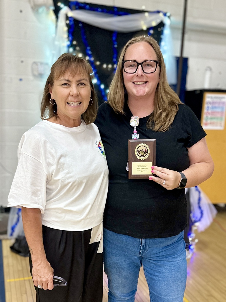 Elizabeth Schuyler of Benson Village School smiles while holding her SVUUSD Executive Board Award alongside a colleague.