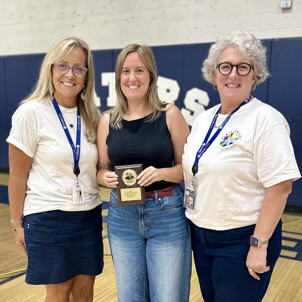 FHGS Grade 4 teacher Margaret Quinn holds her UVM Outstanding Teacher Award while posing with school administrators.