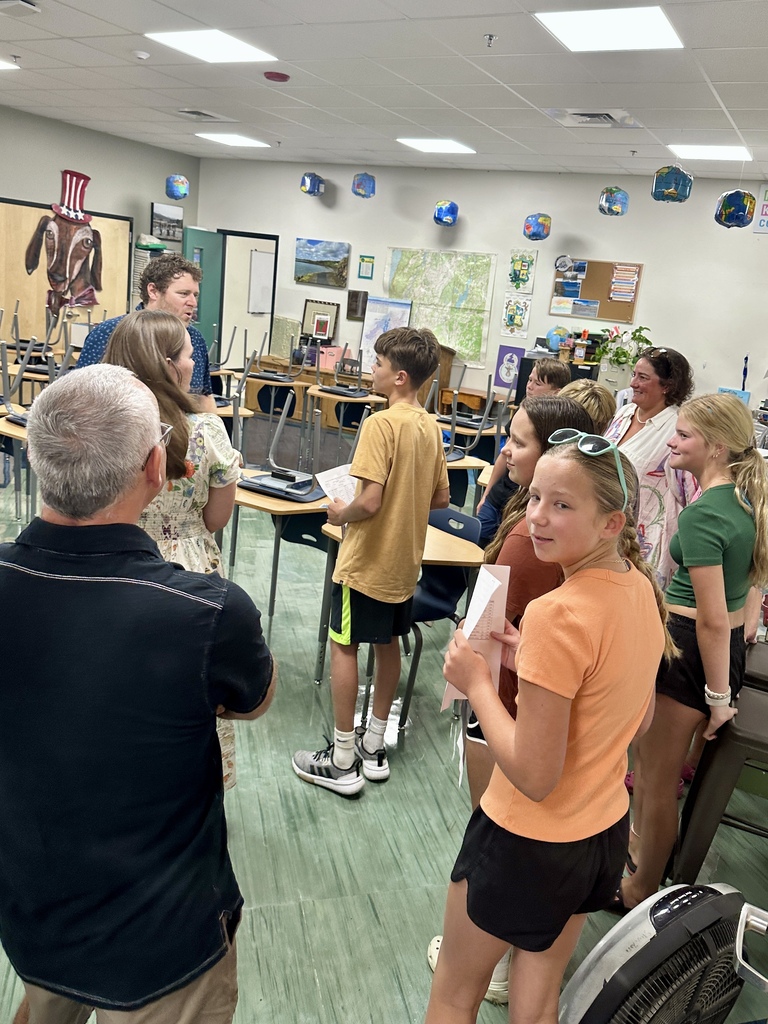 Students, families, and staff gather in a classroom while exploring Fair Haven Union Middle School during Open House.