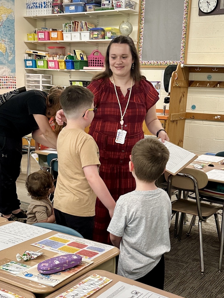 FHGS teacher welcomes and talks with students in her classroom during Open House.
