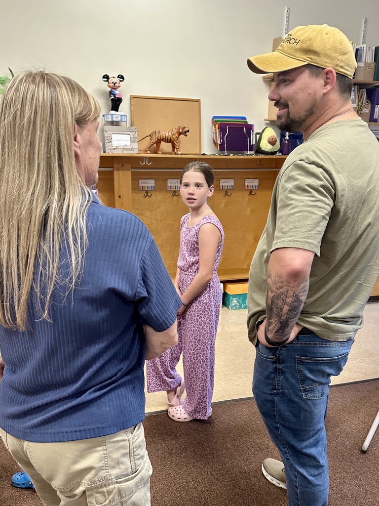 FHGS student and family members talk with a teacher while visiting a classroom during Open House.