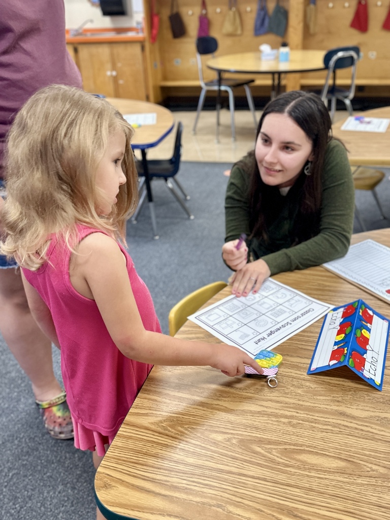 FHGS student talks with a teacher while exploring a classroom activity during Open House.