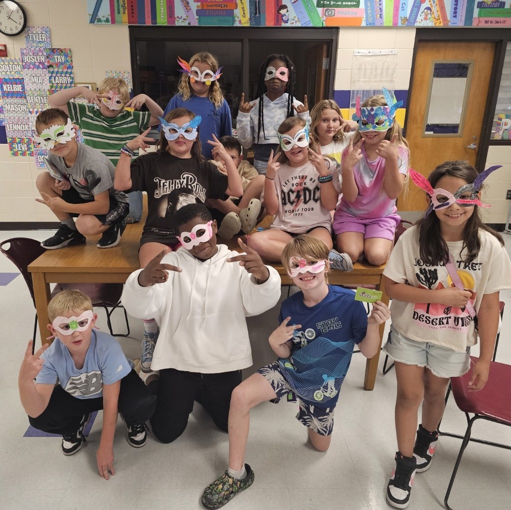 Group of students wearing masks they created after learning about Carnival in Brazil