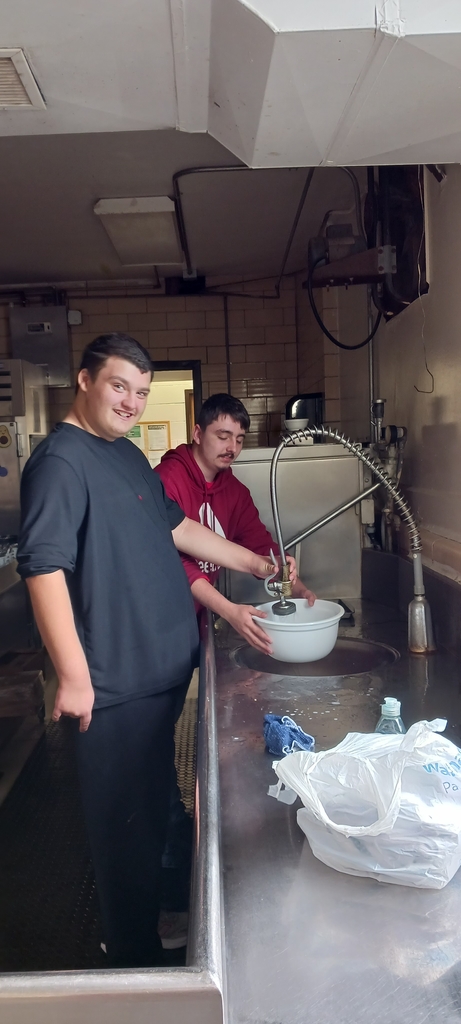 Students working together while cleaning the dishes
