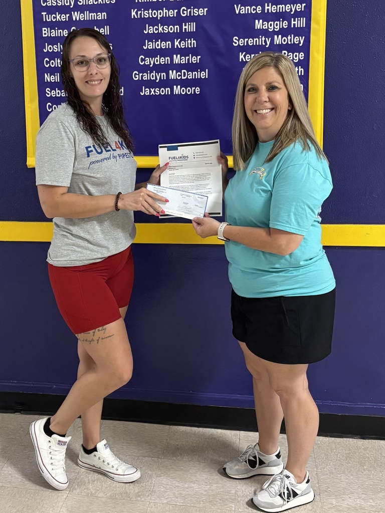 Becky Drummond receiving a donation check from Pipestone employee, Madison Merchant.