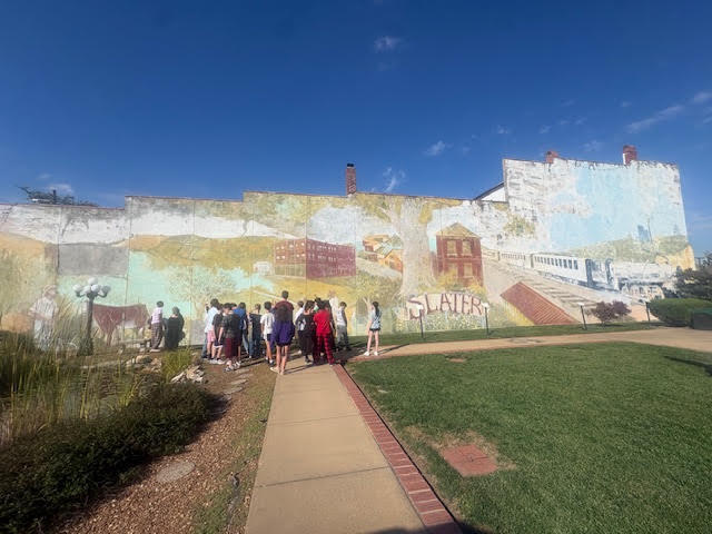 Today, our sixth graders took a walking field trip to Slater Veterans Park to explore the mural in preparation for our upcoming unit on Missouri murals. Students had the opportunity to observe the artwork up close and begin thinking about how murals tell stories, reflect history, and represent a community. It was a beautiful day to get outside, enjoy the sunshine, and explore the artwork!