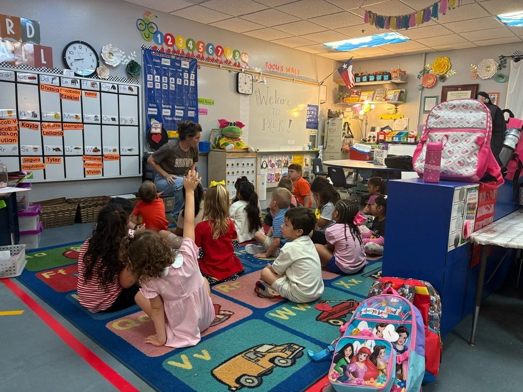 students sitting on rug