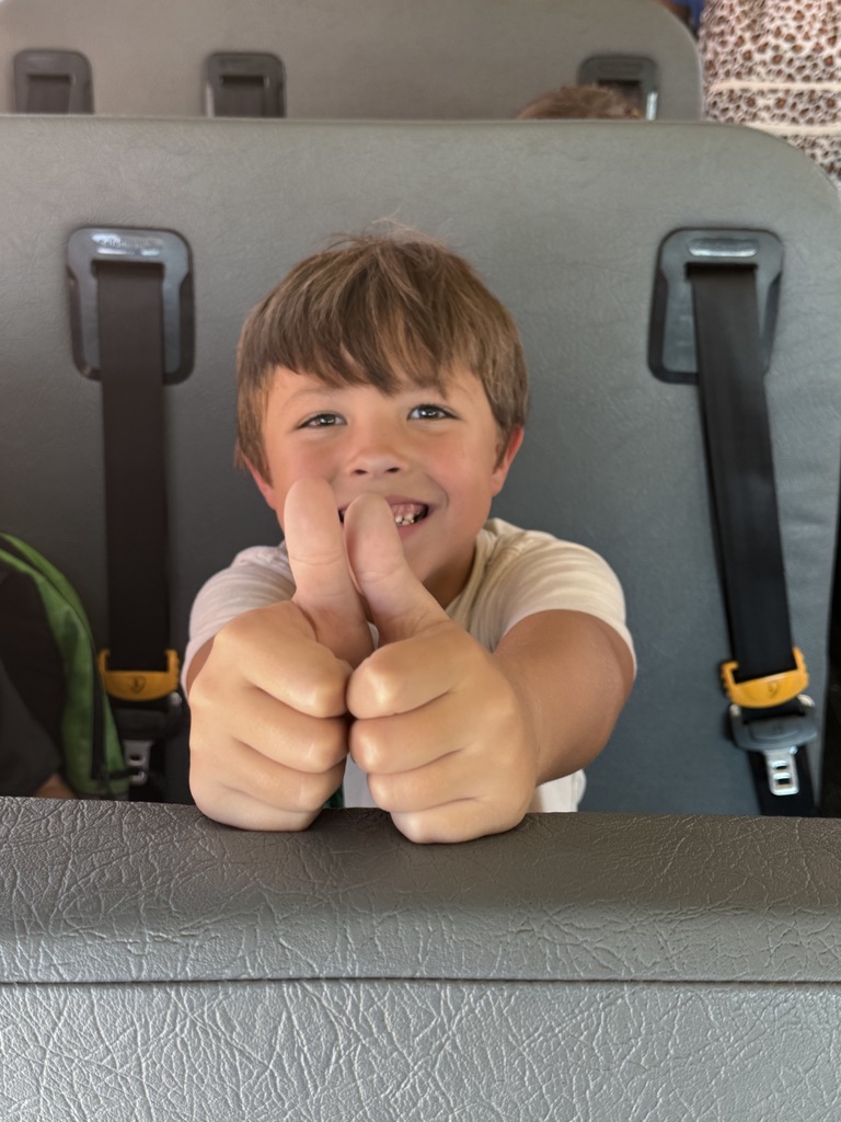 student giving two thumbs up
