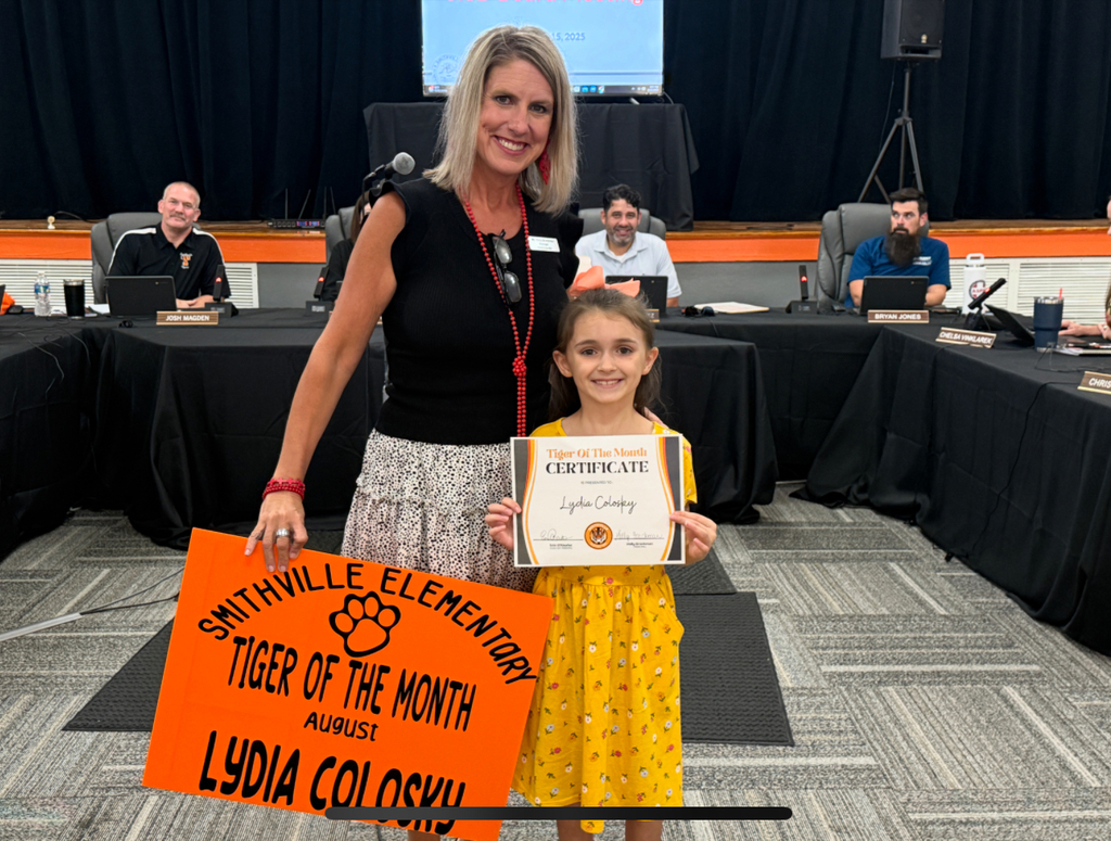 principal and student with award