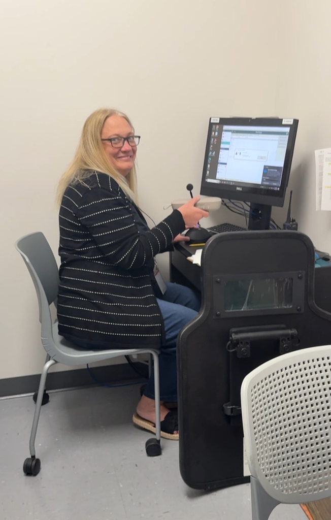 principal sitting at computer