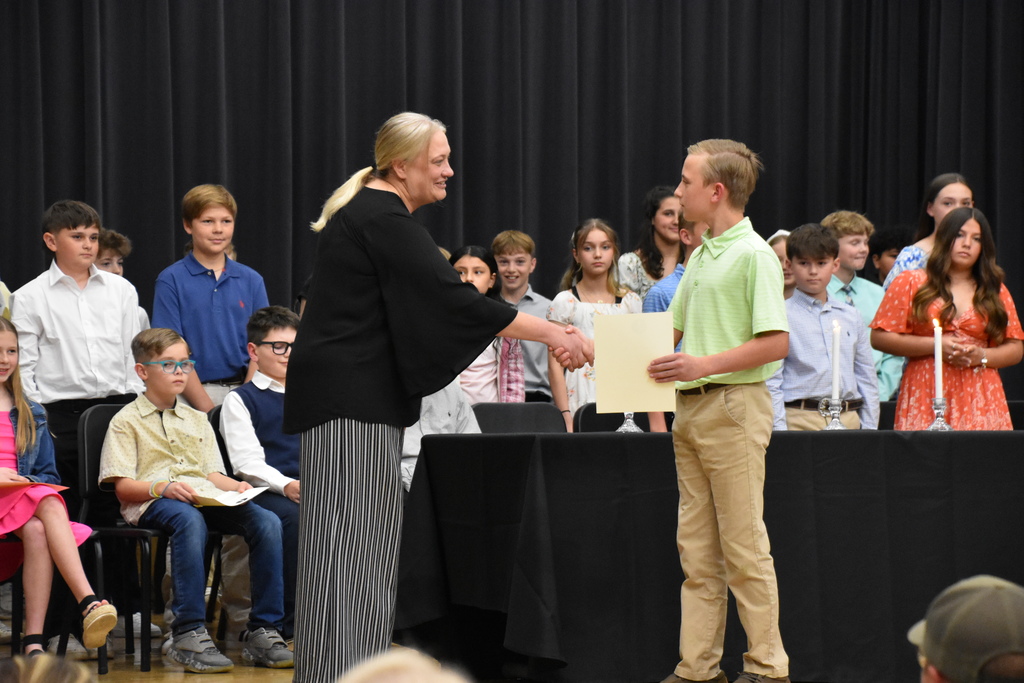 teacher shaking student's hand