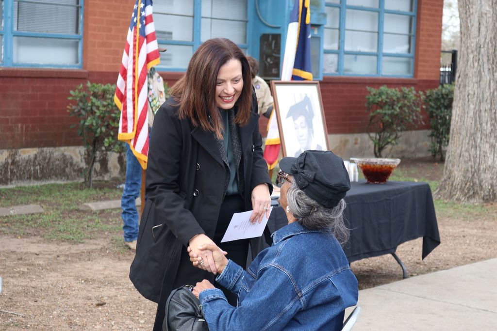 superintendent shaking hand of community member