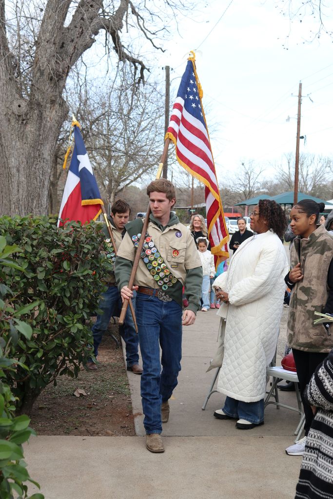 scouts carrying american and texas flags