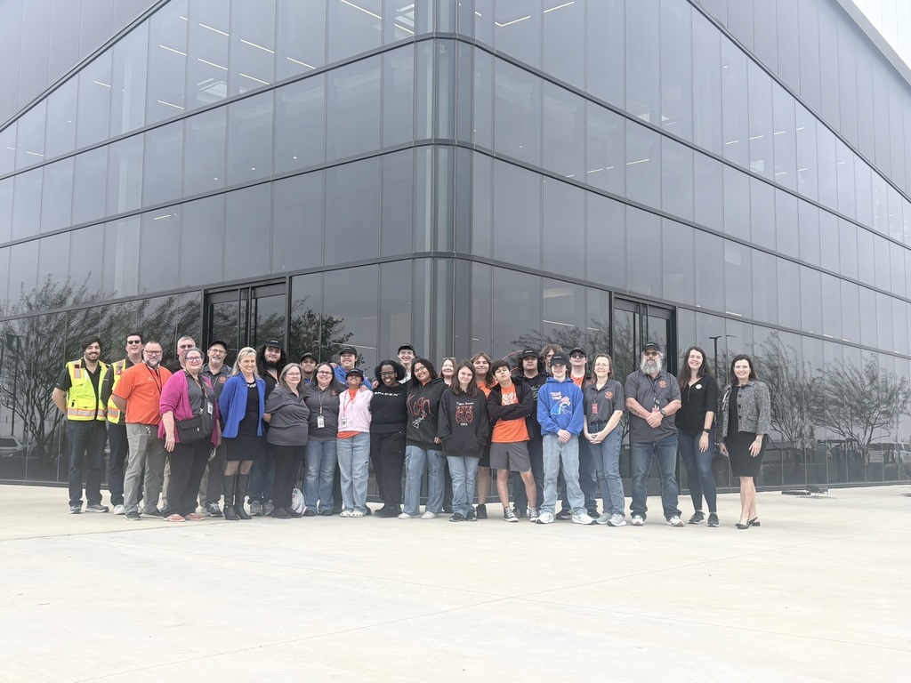 group of people in front of glass building
