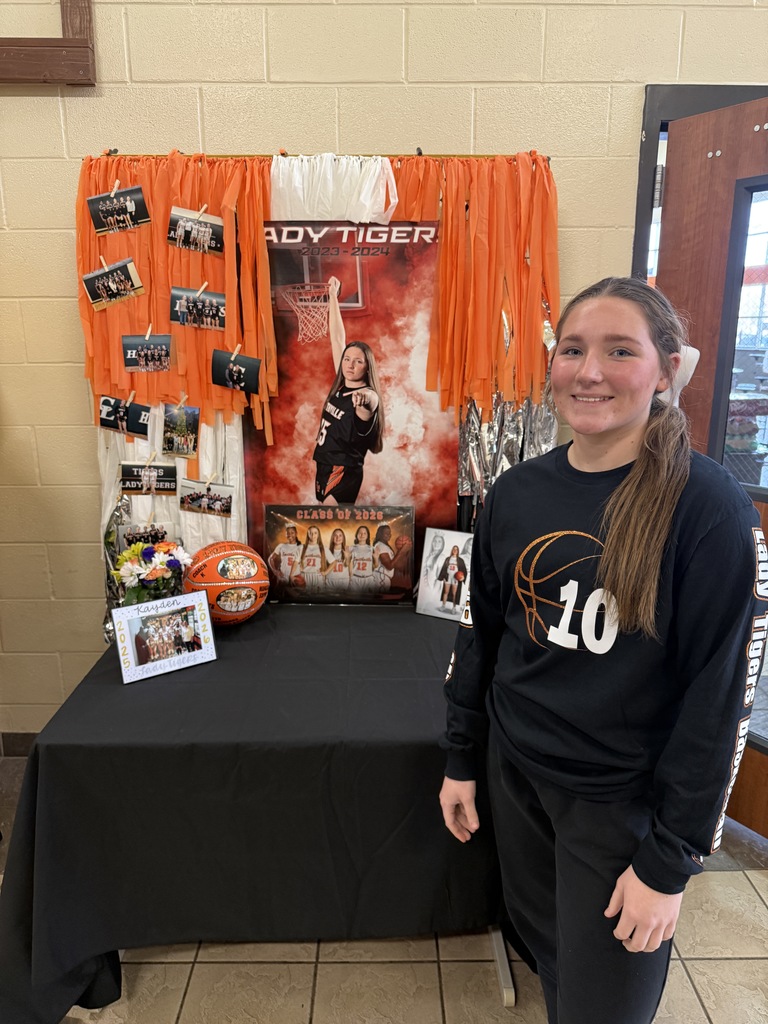 senior at table with photos