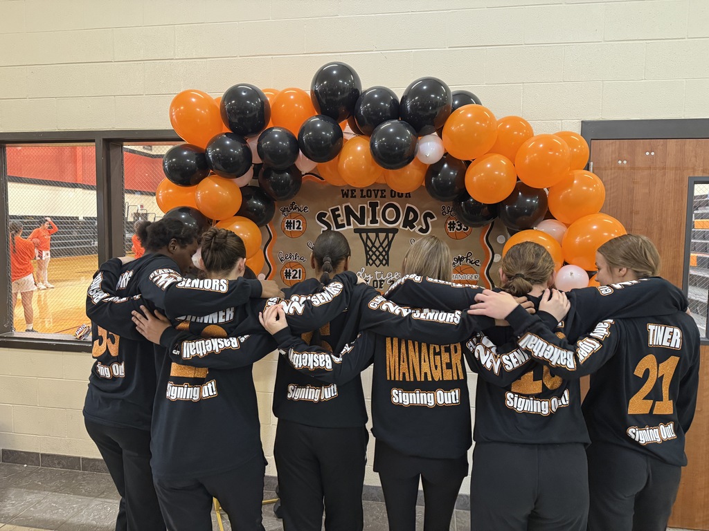 6 senior girls showing backs of shirts