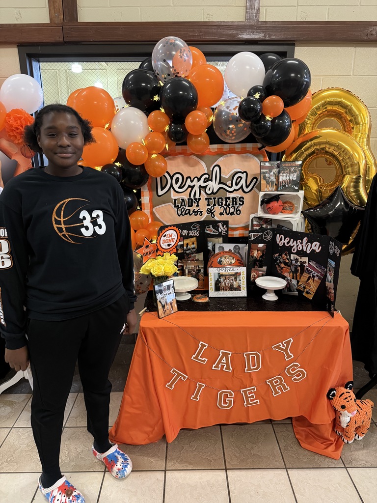 senior at table with photos