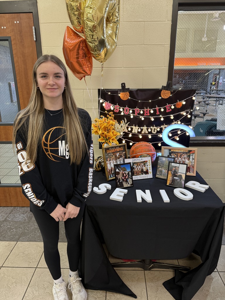 senior at table with photos