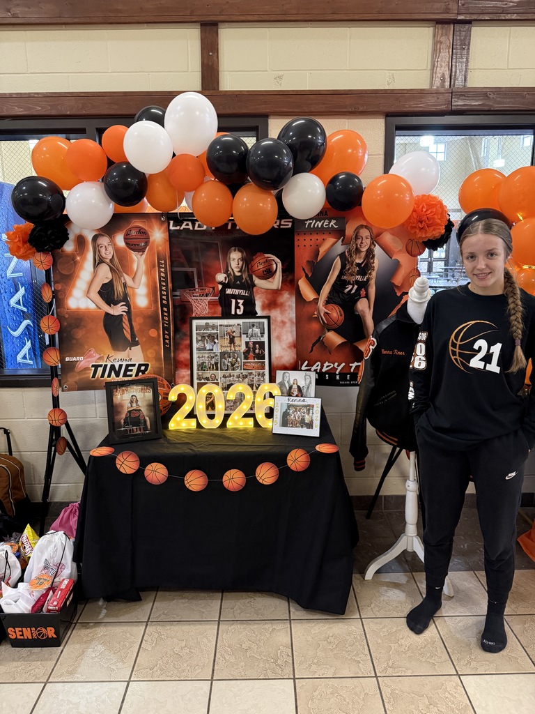 senior at table with photos