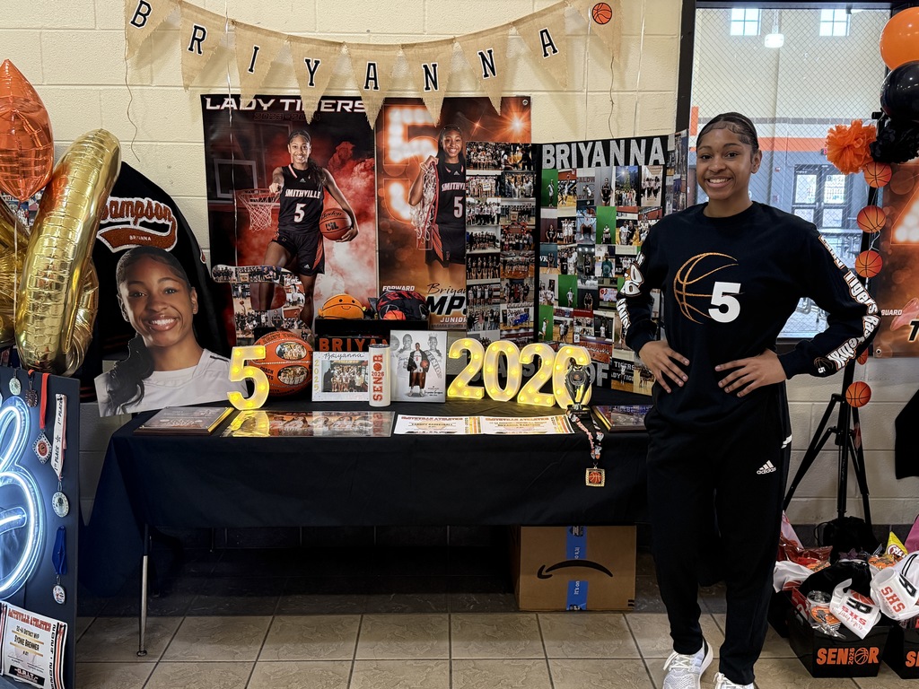 senior at table with photos