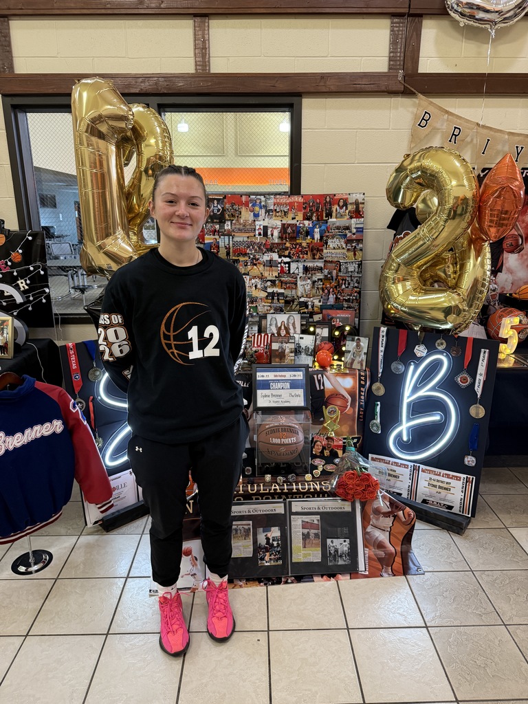 senior at table with photos