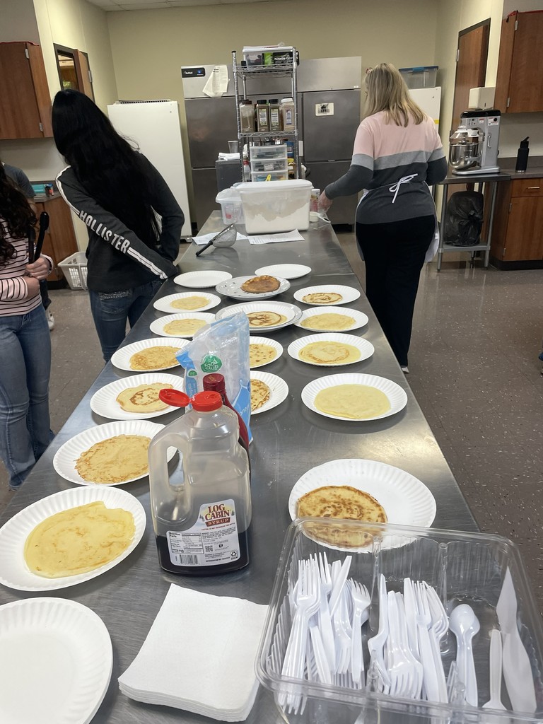table full of plates with pancakes