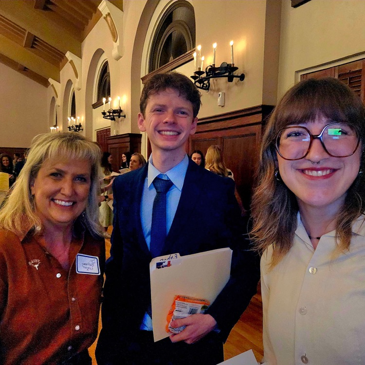 three adults taking a selfie