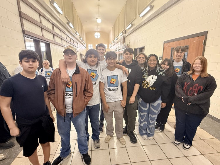 students standing together in a hallway 