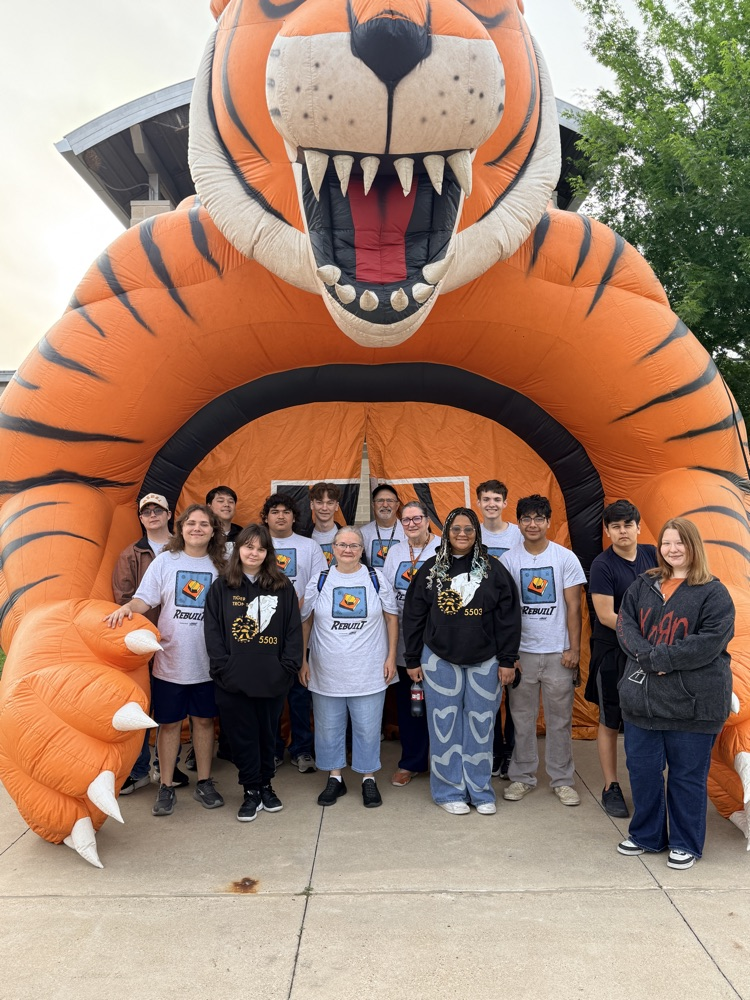 students standing in front of a blowup tiger 