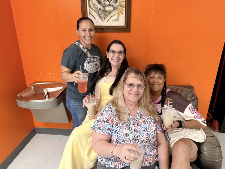 four ladies sitting around a big chair