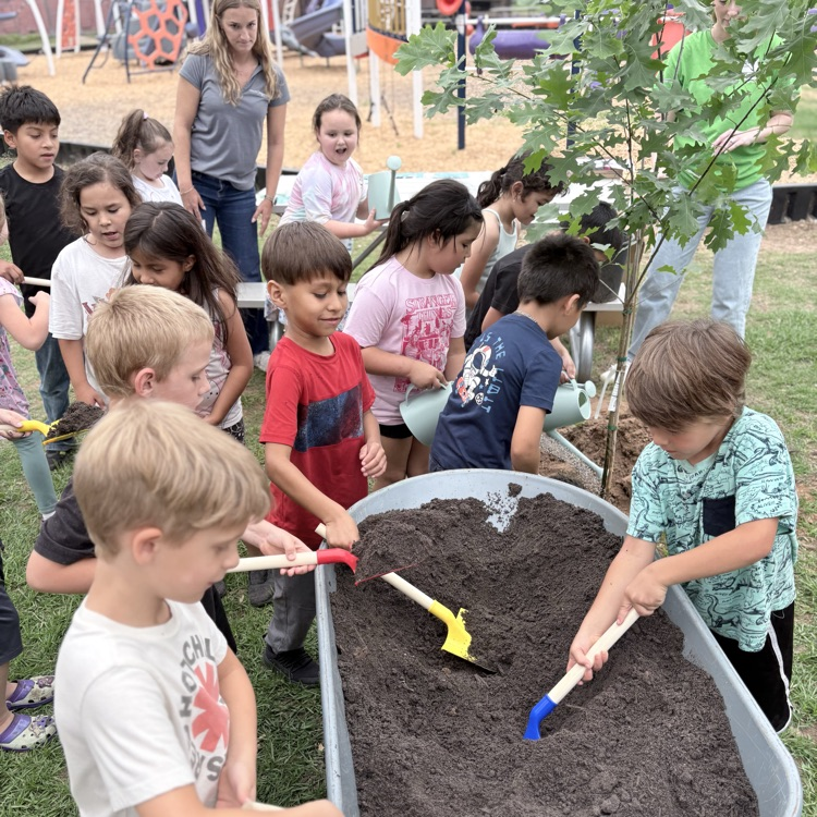 students digging in a  wheelbarrow 