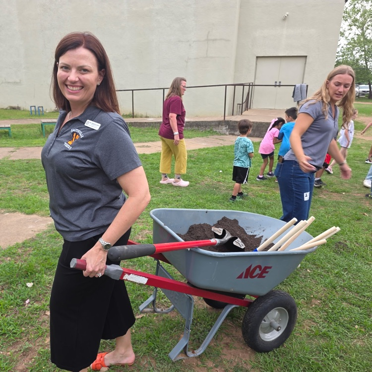 woman pulling a wheelbarrow