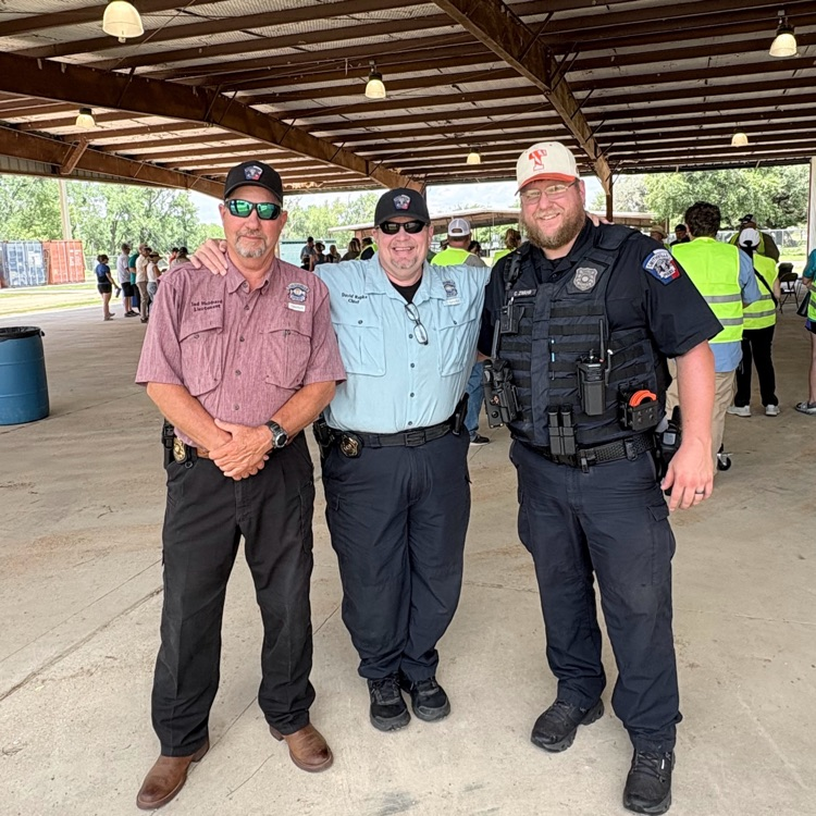 three police officers stand together