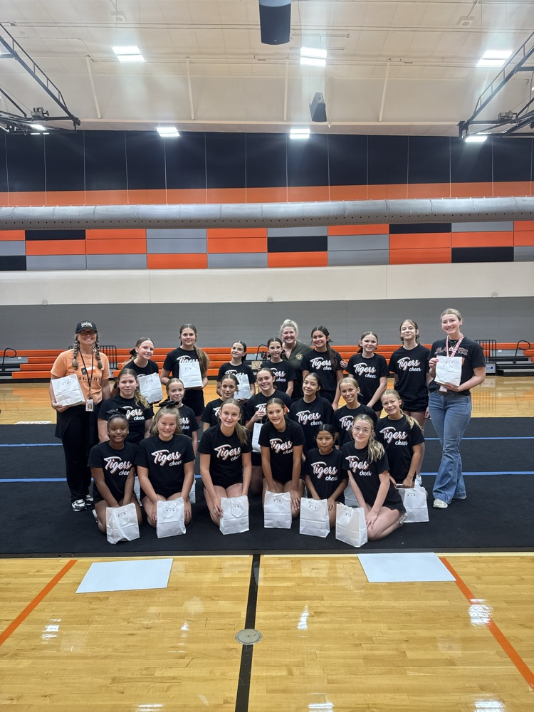 a group of cheerleaders poses with goodie bags