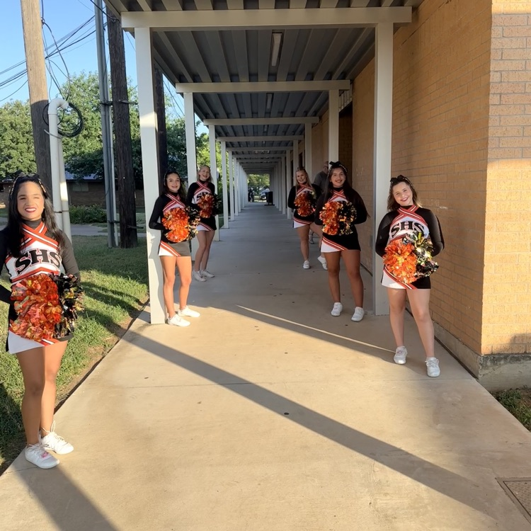 cheerleaders greeting people