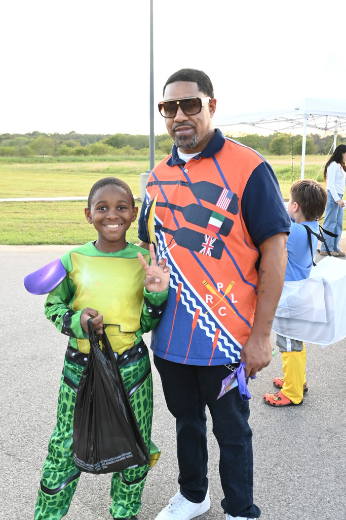 a boy and a man stand together at a halloween gathering
