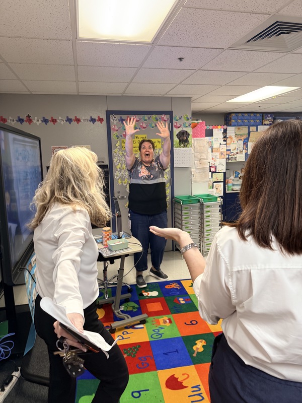 teacher excited with her hands in the air