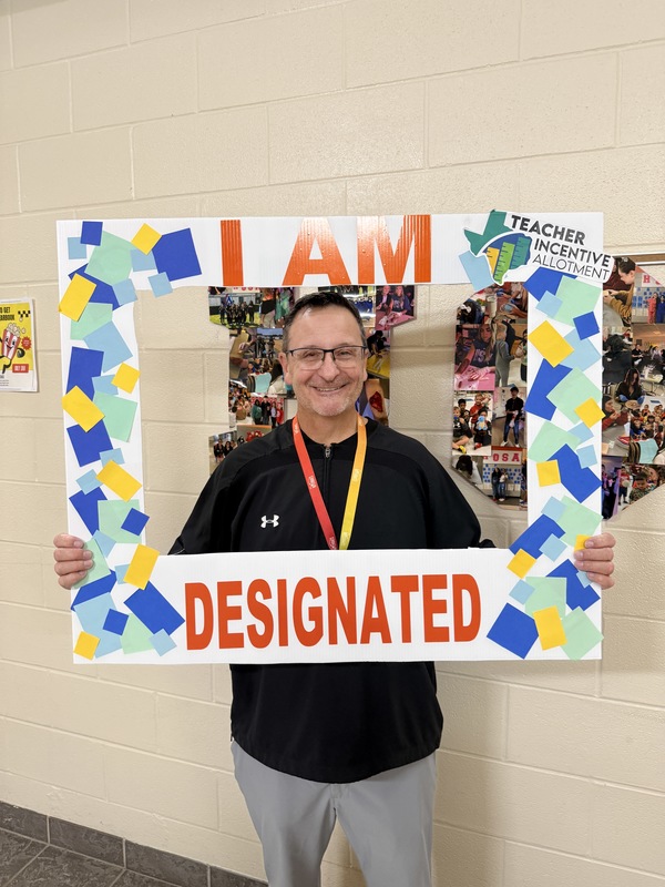 teacher holding a sign that says "I AM DESIGNATED"
