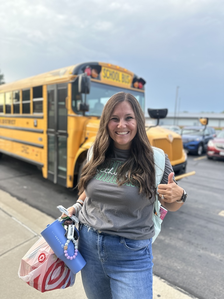 A High School teacher gives a thumbs up