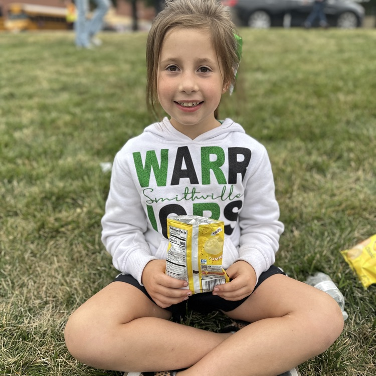 Little girl in a warrior shirt, smiling at the camera