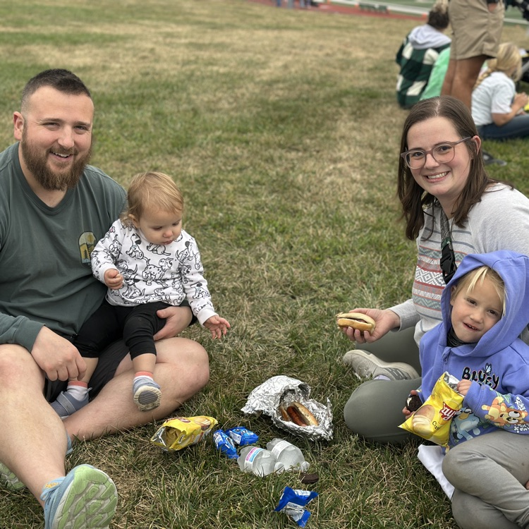 A family enjoying the tailgate party with a picnic