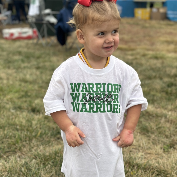 A little girl in a big warrior T-shirt