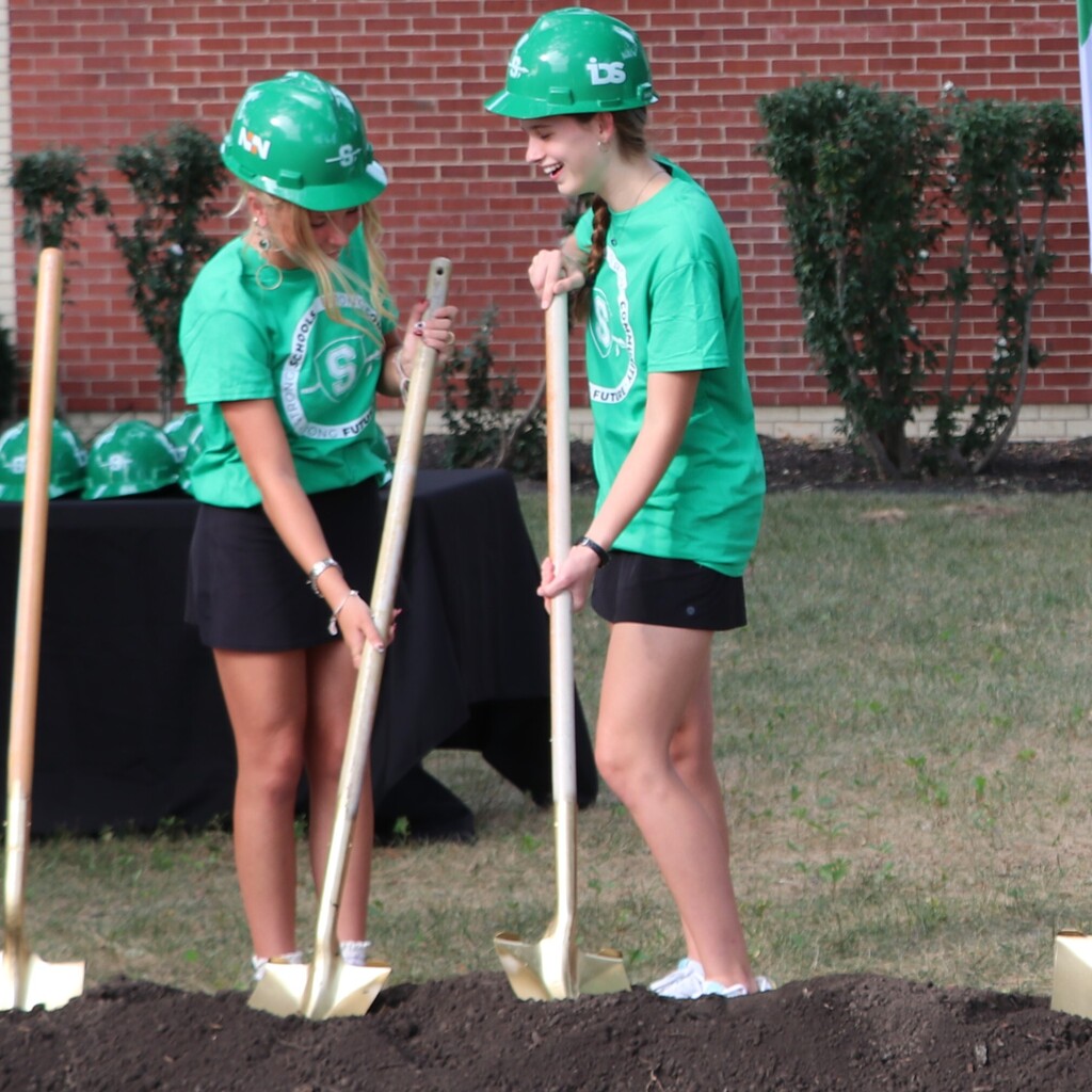 Girls laughing while they dig