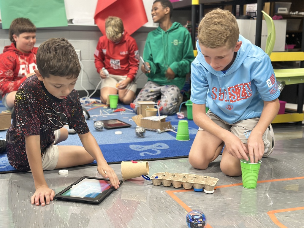 6th Grade students test how many marbles their robot can pull