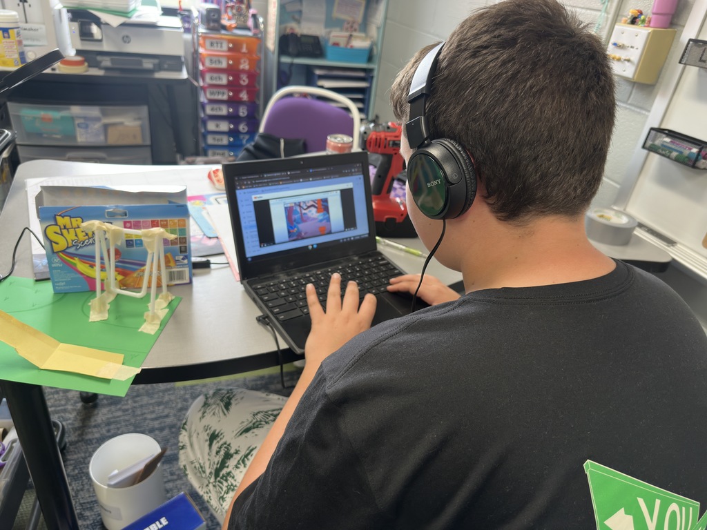 6th Grade student uses laptop to play a coding game