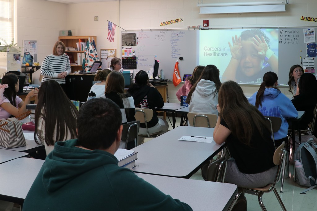 Students listen to a presentation on health care professions at the college and career fair