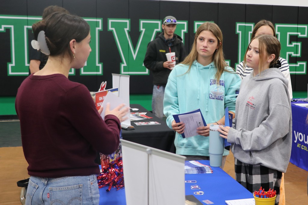 Students speak to a college recruiter at the college and career fair