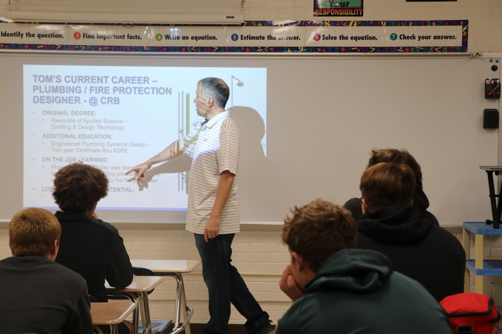 Students listen to a presentation on engineering and drafting professions at the college and career fair